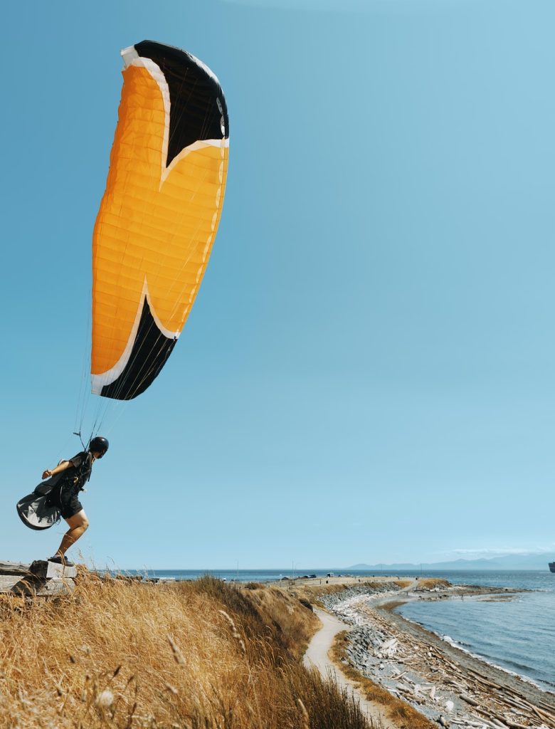 paraglider-paraglider-standing-on-the-edge-of-pacific-ocean-cliff-oceanview-.jpg