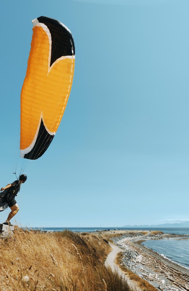 paraglider-paraglider-standing-on-the-edge-of-pacific-ocean-cliff-oceanview-.jpg