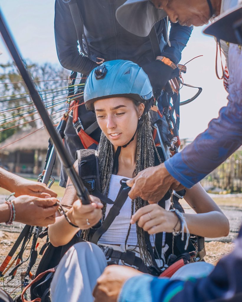 shot-of-people-preparing-woman-for-skydriving-in-bali.jpg